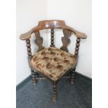 An early 20th century oak corner chair on bobbin legs