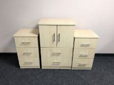 A contemporary linen chest fitted two drawers together with a pair of matching three drawer bedside