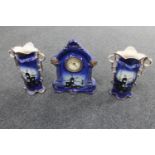 A 19th century three piece pottery clock garniture depicting windmills