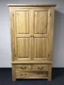 A contemporary oak double door wardrobe fitted three drawers beneath