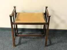 An inlaid mahogany Arts & Crafts piano stool