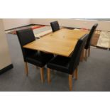 A contemporary oak turn over topped dining table together with four leather chairs