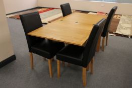 A contemporary oak turn over topped dining table together with four leather chairs