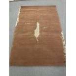A hand-knotted rug with leaf design on brown ground,