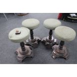 A set of four circular twist column bar stools on wooden bases