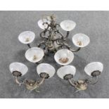 An ornate metal six way light fitting with glass shades together with a pair of double wall lights