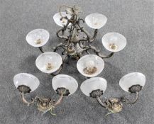 An ornate metal six way light fitting with glass shades together with a pair of double wall lights