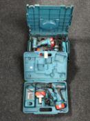 A cased Makita 14 volt twin drill set with battery and charger,
