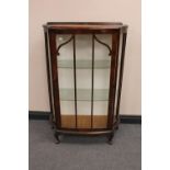 A 1930's walnut single door display cabinet