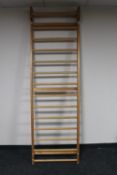 A pine wall mounted clothes rail