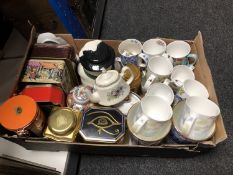 A box of a quantity of Ringtons tins, vases, teapots,