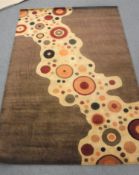 A hand-knotted rug on brown and sand ground,