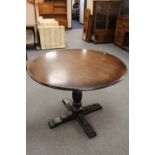 A circular oak pedestal pub style table