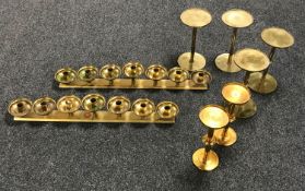 A pair of brass seven branch candelabrum and three pairs of brass stands