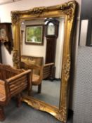 A gilt framed ornate bevelled mirror,