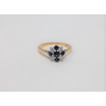 An 18ct gold and platinum set diamond and sapphire ring