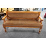 A wood framed pub settee