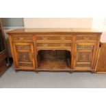 A Victorian oak sideboard with carved panel doors