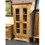 An Oak Furniture Land oak bookcase with glazed doors,