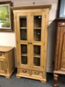 An Oak Furniture Land oak bookcase with glazed doors,