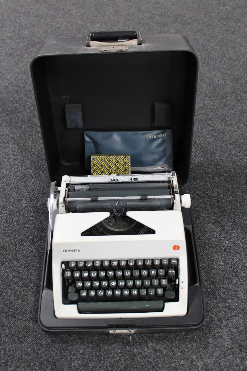 A cased Olympia International typewriter