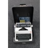 A cased Olympia International typewriter