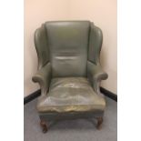 An early twentieth century leather wingback armchair