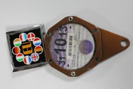 A European Union nine flags car badge number 3679 and a motorbike tax disc holder