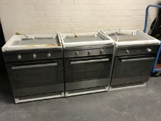Five stainless steel integrated ovens in cupboards