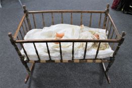 An Edwardian rocking crib together with a plastic headed doll