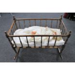 An Edwardian rocking crib together with a plastic headed doll