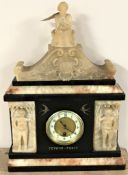 A 19th century slate mantel clock with brass and enamelled dial surmounted by a seated figure