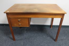 A mid 20th century teak desk fitted two drawers