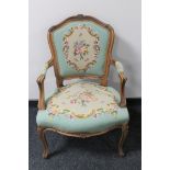 A carved continental salon armchair upholstered in a tapestry fabric