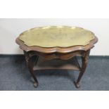 A continental oak shaped two tier serving table with lift out brass tray