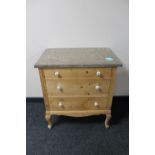 An early 20th century pine three drawer marble topped chest