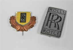 A 20th century Rolls Royce metal emblem Ghost Wraith Dawn badge and a vintage tin Rolls Royce badge