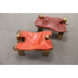 Two camel stools with leather saddles