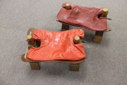 Two camel stools with leather saddles