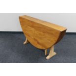 An Ercol pine drop leaf table