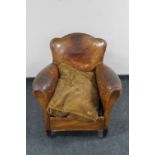 An early 20th century brown leather club armchair