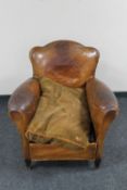 An early 20th century brown leather club armchair