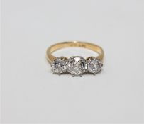 An 18ct gold three-stone diamond ring,