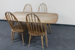 An Ercol elm dining table and four spindle back chairs