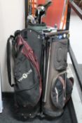 Three golf bags containing various clubs,
