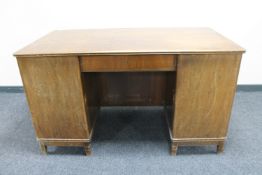 A mid 20th century continental walnut twin pedestal desk