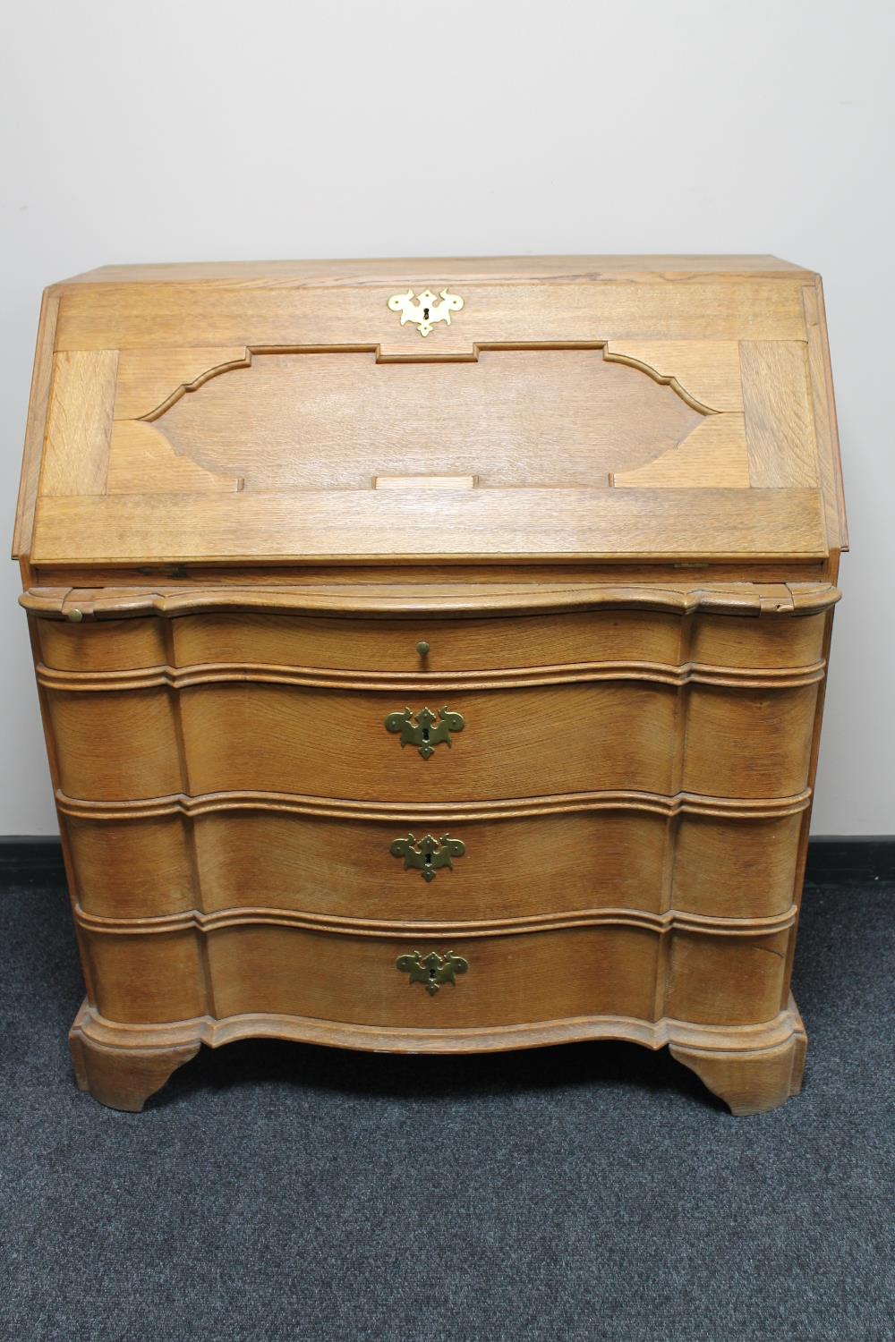 An antique continental oak bureau