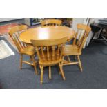 A contemporary oak circular dining table and four chairs