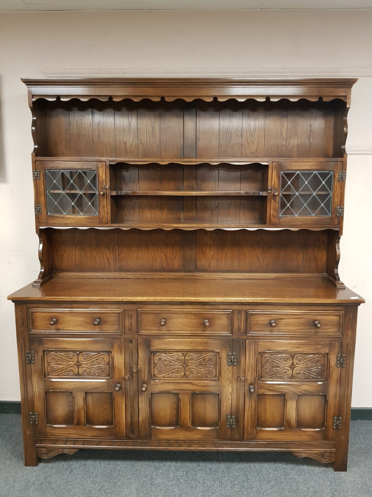A Reprodux oak traditional style dresser,