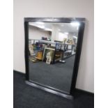 A black framed overmantel mirror
